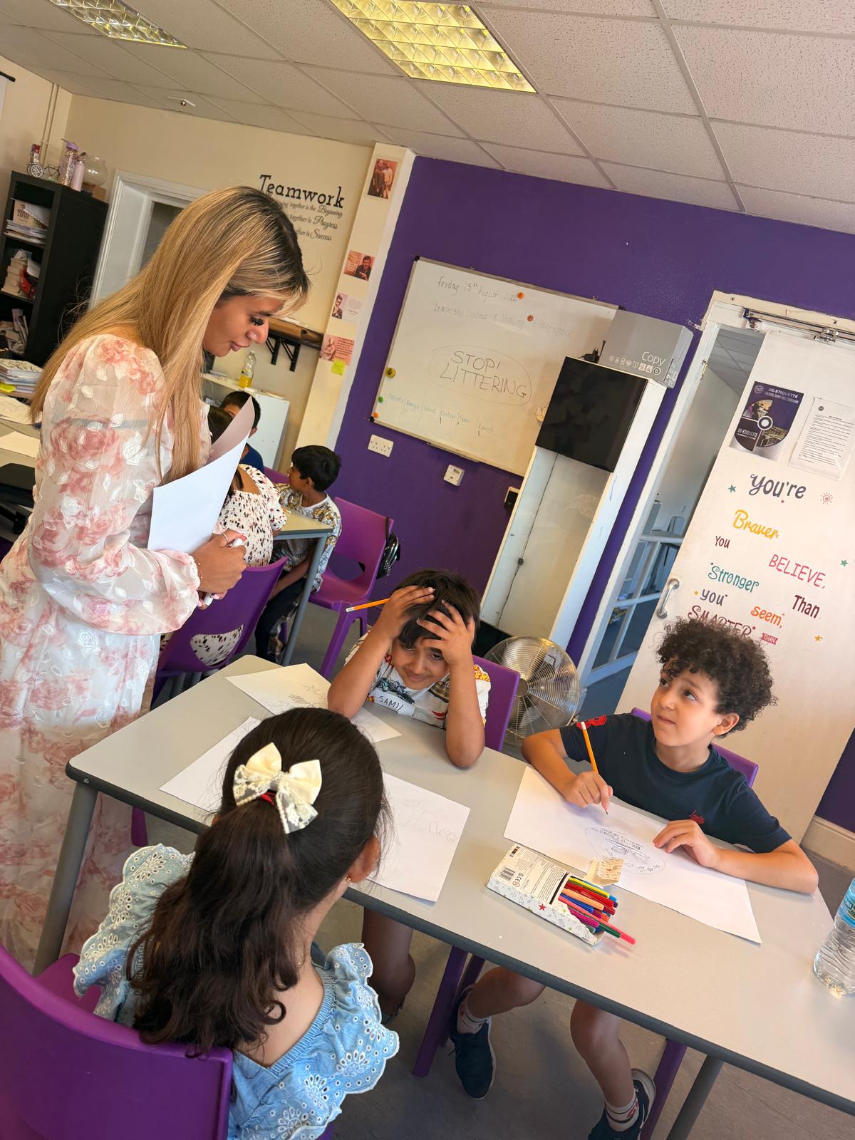A tutor supporting children with their learning activities