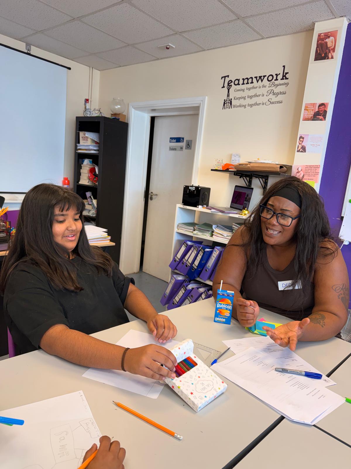 A mentor working one-to-one with a young person