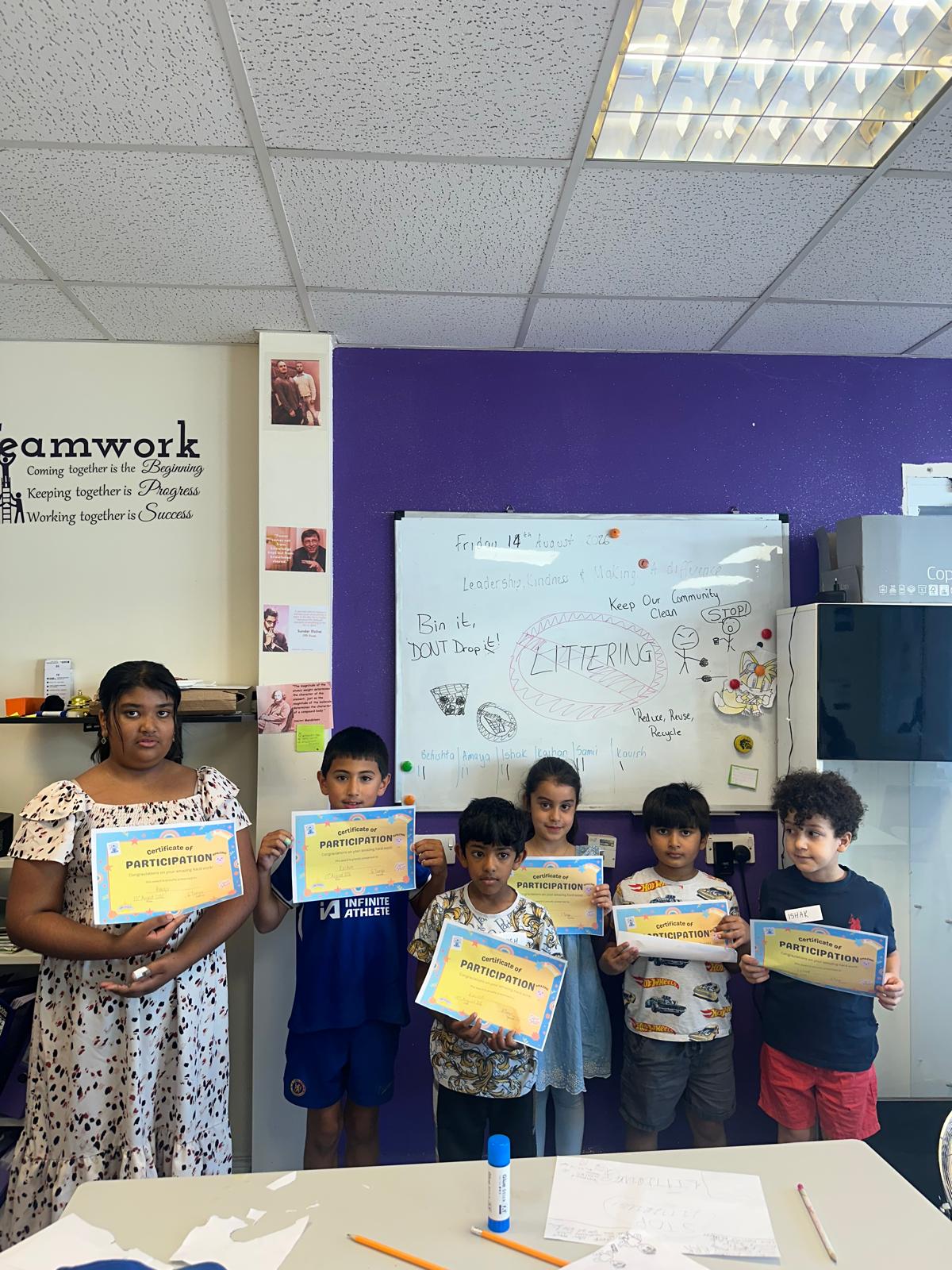 Children proudly holding their certificates of participation